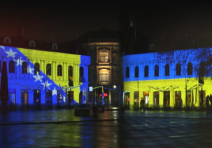 Barok building in Tuzla lit in colours of Bosnian and Ukrainian flags