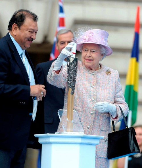 Her Majesty placing her message into the Baton