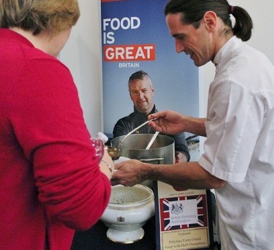 Chef Craig serves oxtail soup at the Empty Bowls event for hunger relief.