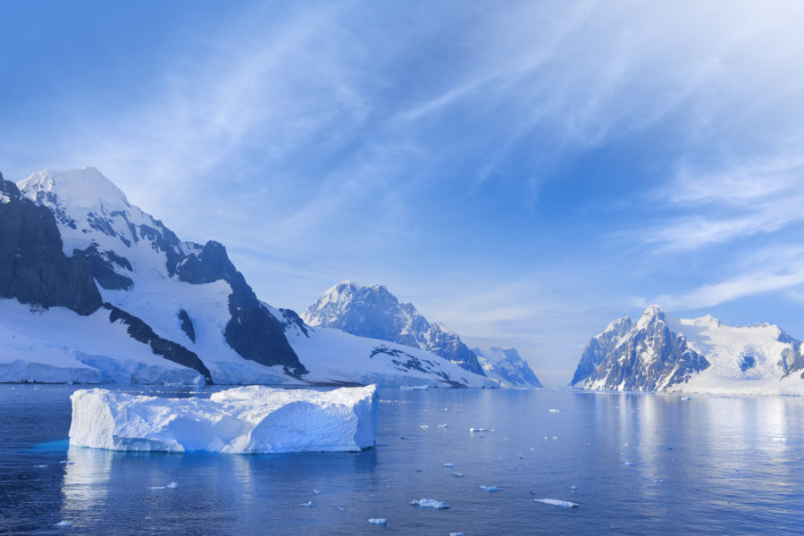 A landscape of an icy haven. A lake is surrounded by land and icebergs