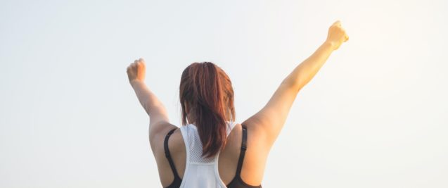 Woman with arms in air