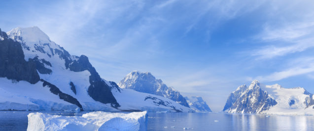 A landscape of an icy haven. A lake is surrounded by land and icebergs