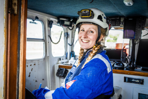 MCA Surveyor Pippa Whalley stands in the wheelhouse of a vessel while conducting an inspection.