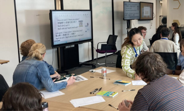A mixed group of people taking part in a Cantonese lesson.