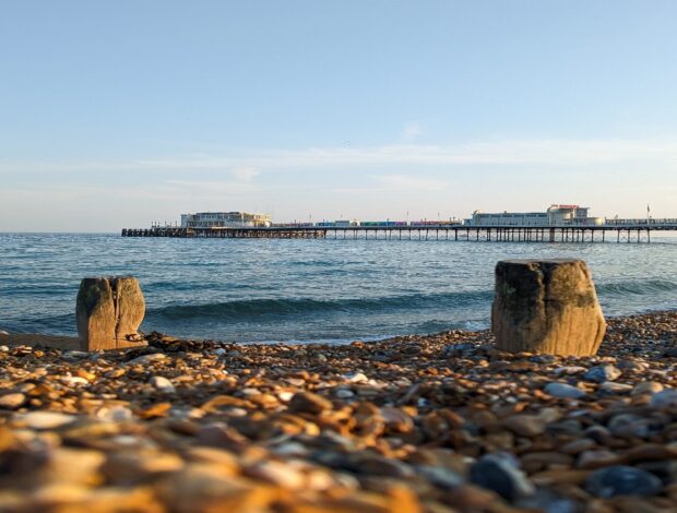 A beach and pier on a sunny morning