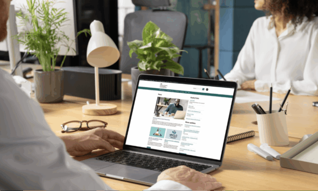 a laptop screen showing the new intranet homepage