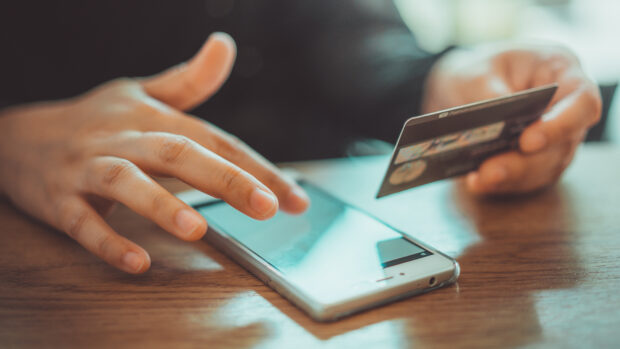 Shopping on a phone with a debit card.