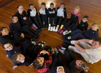 Pupils in a circle looking up at the camera