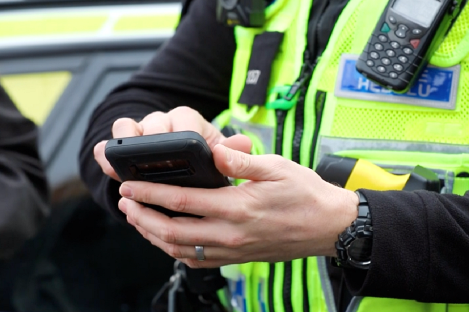 police officer holding mobile device