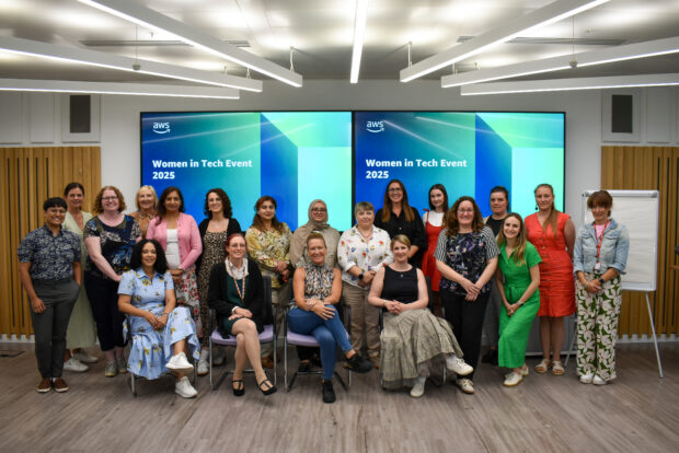 Group of women in an office environment smiling to camera