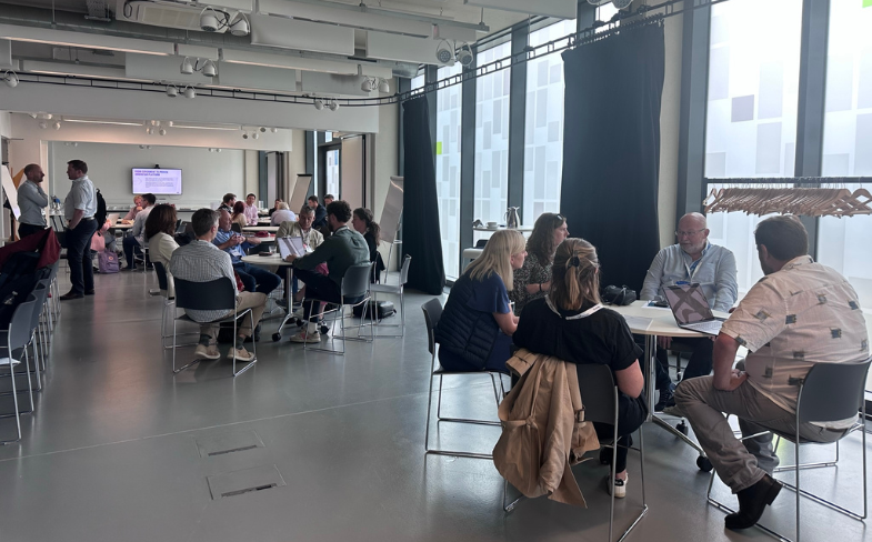 People in chairs taking part in breakout discussions