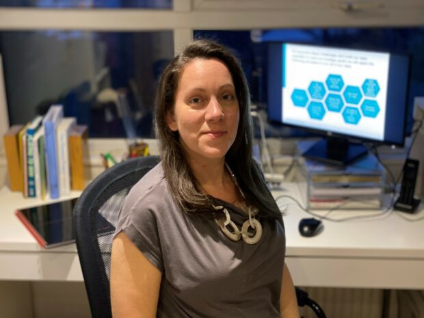 Katharine Purser sat at her desk with a computer screen.