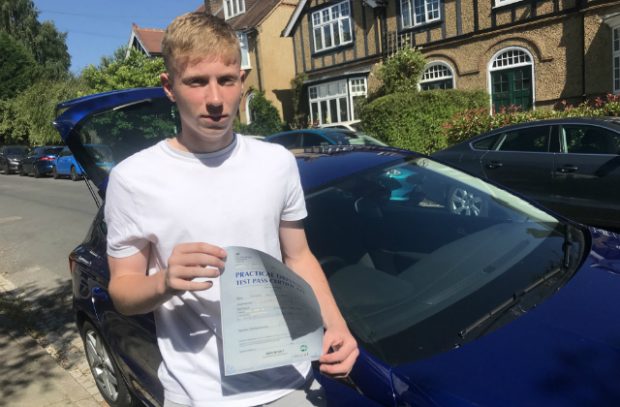 Finbar King holding driving test pass certificate