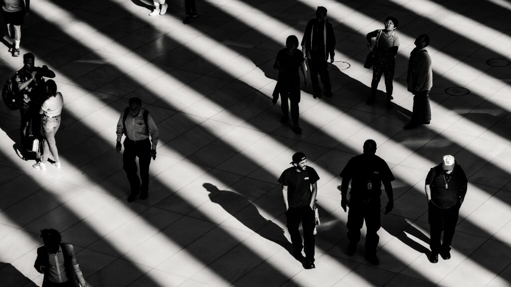 Black and white image of people walking from above