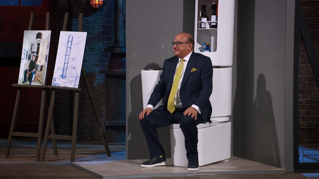 Touker Suleyman tries out the compact Vertebra bathroom by inventor Paul Hernon.