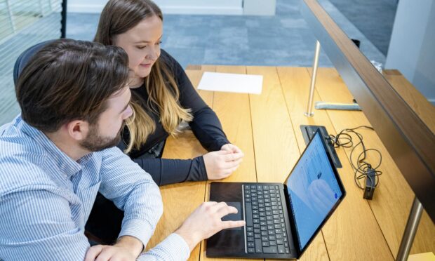 two people working on a laptop together
