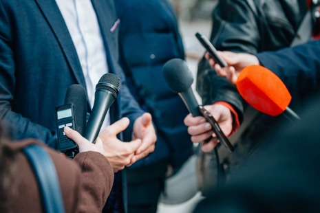 people holding microphones and recorders