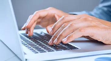 A person typing on a keyboard
