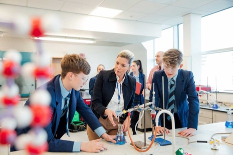 A teacher and some students in a science lab.