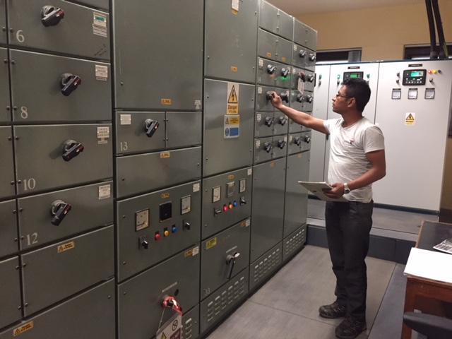 One of our Nepali team working in the Standby Generator Room. [Crown Copyright]