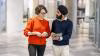 Colleagues walking across our Stratford office and having a conversation