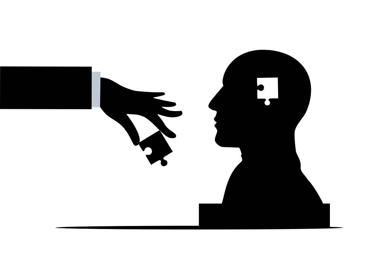 A silhouette of a head and shoulders with a jigsaw piece shape