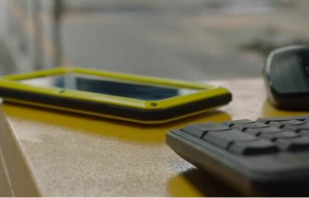 Computer keyboard and mobile phone on a desk