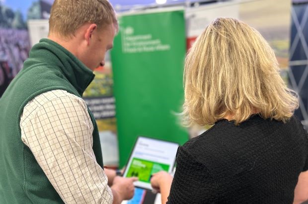 Defra employee talks to member of the farming community at a agricultural show