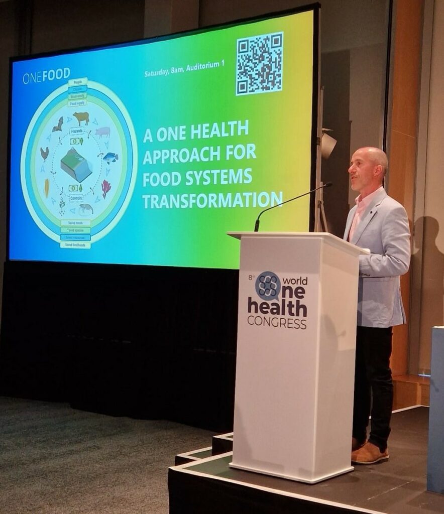 grant stentiford standing on a podium giving a presentation