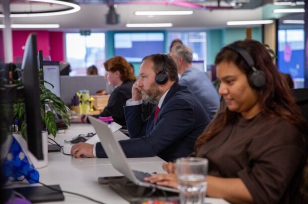Rt Hon Ian Murray MP, Minister for Digital Government and Data, sitting at a desk in front of a computer while wearing a headset microphone