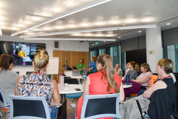 A group of attendees listening to a presentation