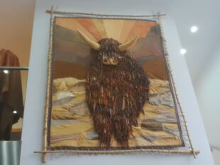 Picture of a Highland cow done in leather.