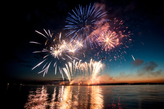 An image of fireworks above the sea