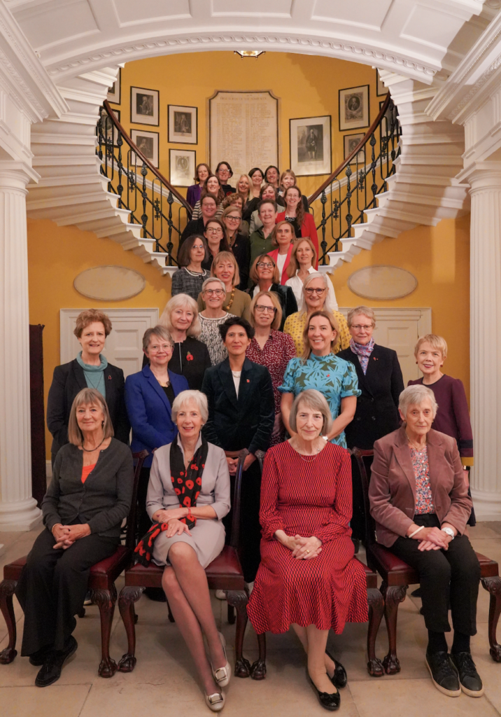Thirty three women permanent secretaries sat in stood in rows in Admiralty House