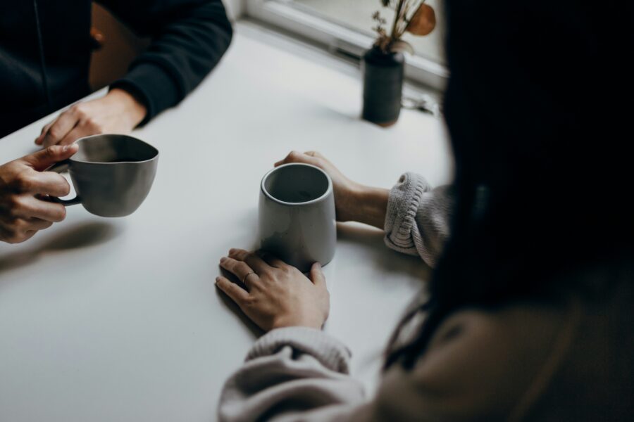 Two people having a conversation over a cup of tea.