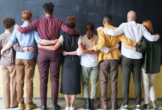 Group of people facing a blackboard