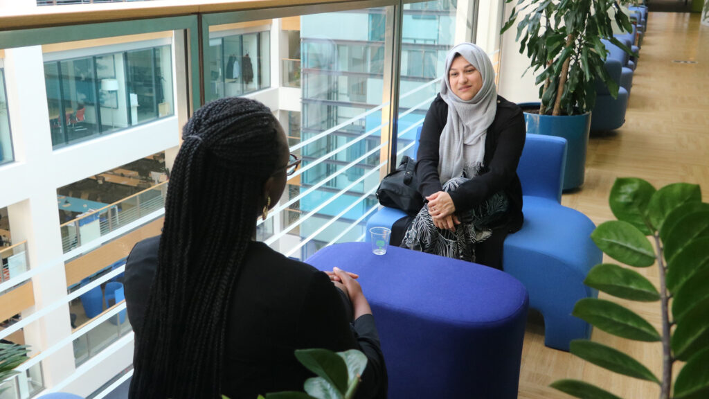 Two female colleagues sitting opposite each other in discussion