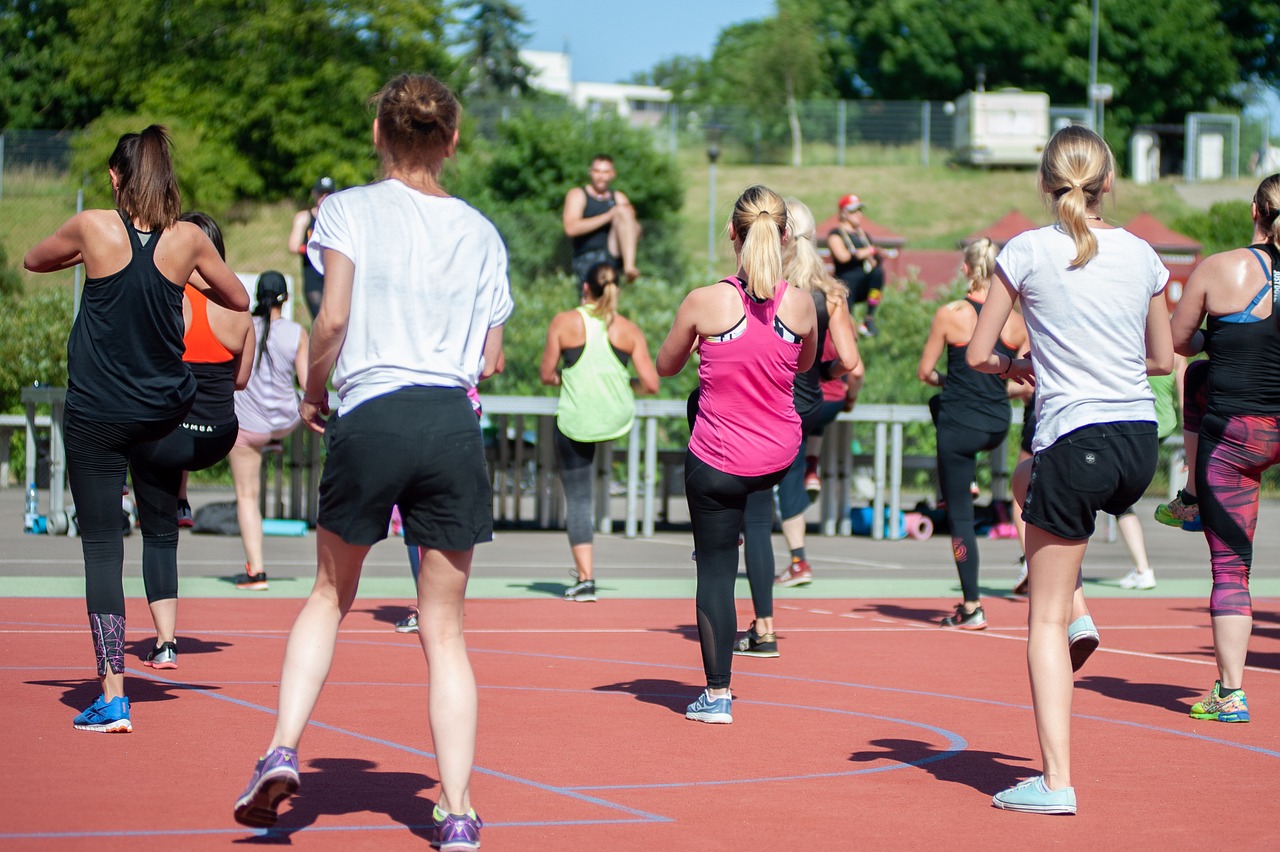 group of people exercising on an outdoor track