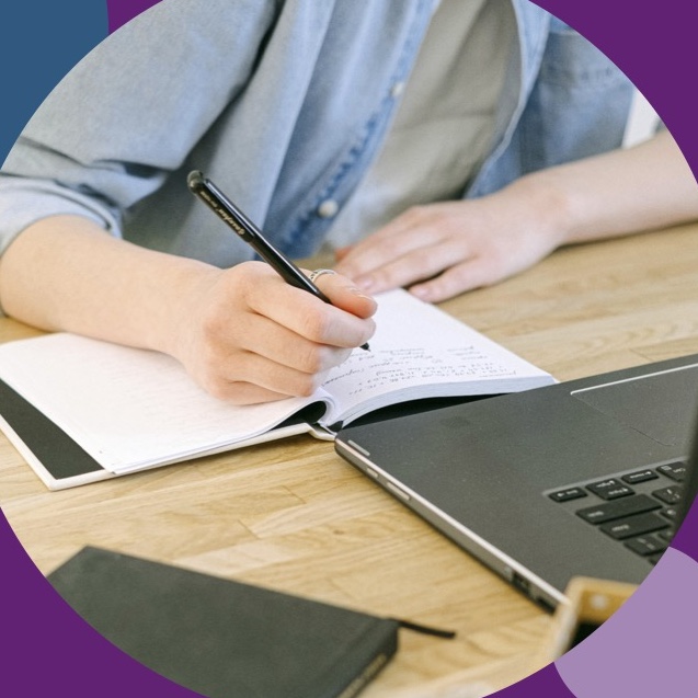 person writing in a notebook
