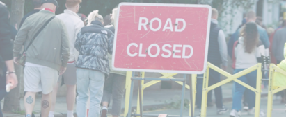 People walking around a “Road Closed” traffic sign with a modular VSB behind it
