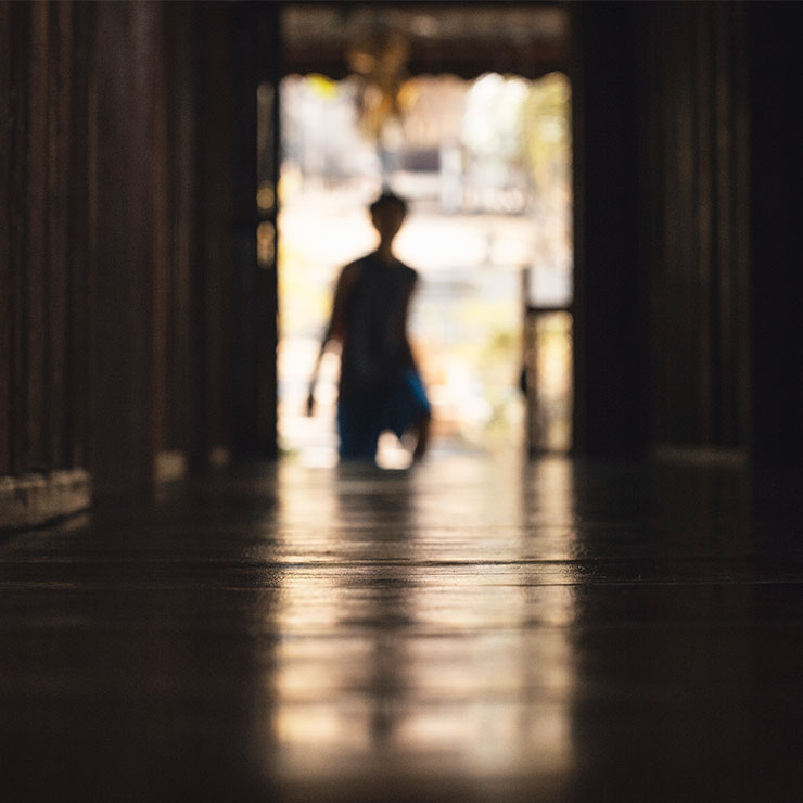 Stranger standing at the end of a dark alley way