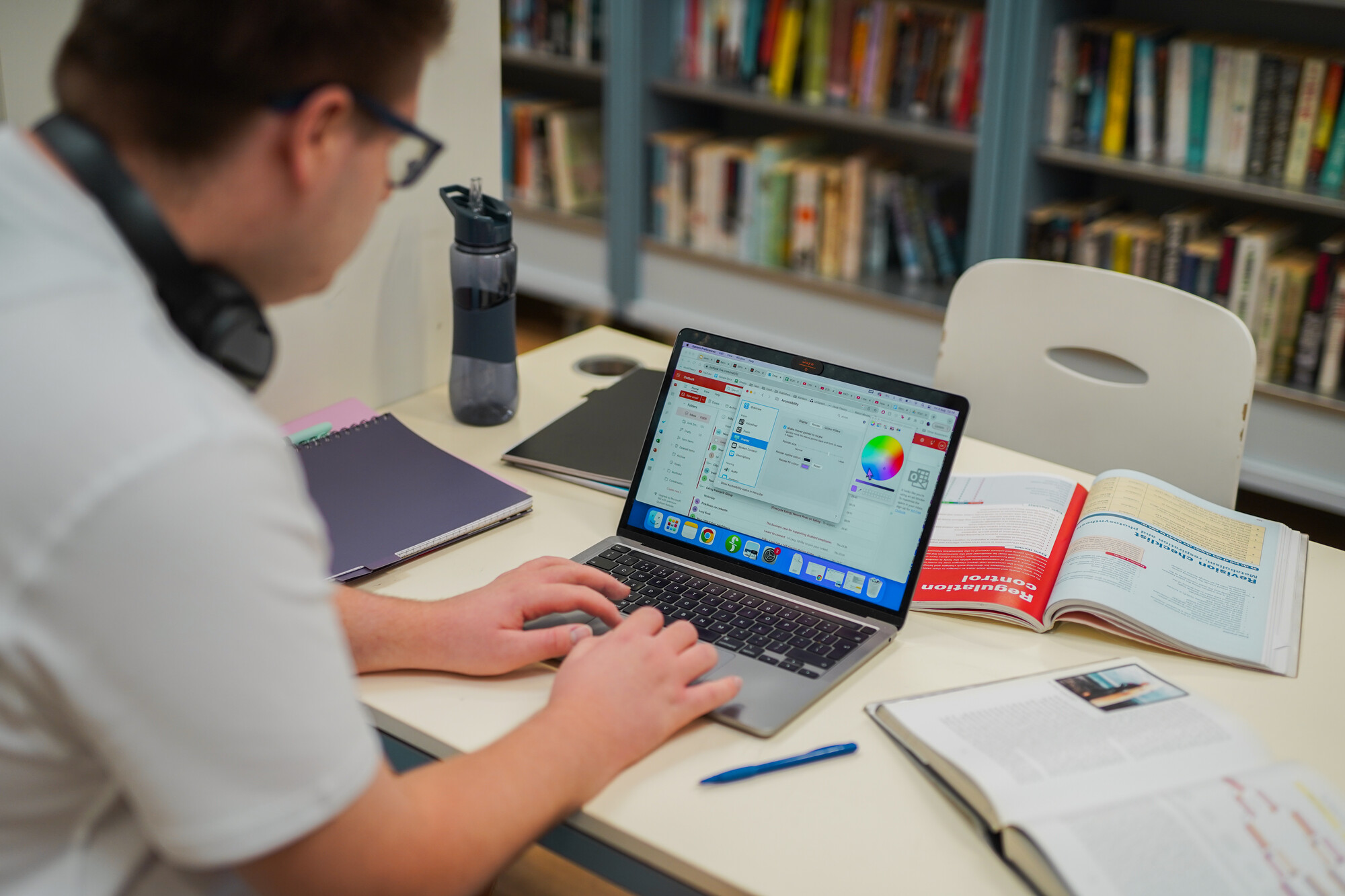 A man with a less visible disability working on a laptop.