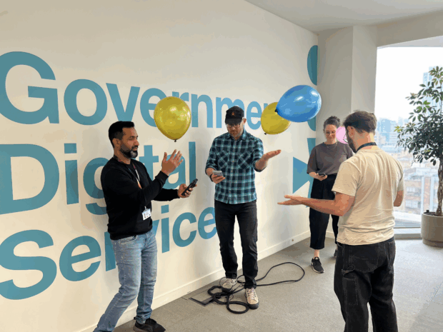 A user-centred design team playing ‘empathy balloons’, a simple, cheap and engaging game to build empathy for people with diverse needs, especially those experiencing issues with cognition and/or dexterity.